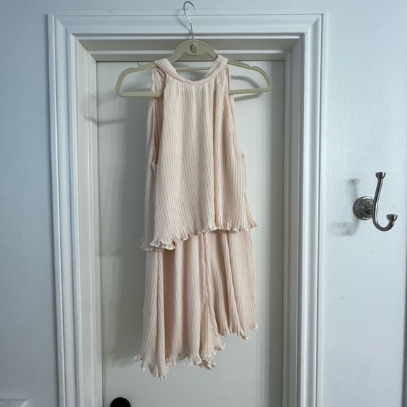 Adorable cream chiffon ruffle short romper with tie back. Open winged back. - Picture 6 of 13